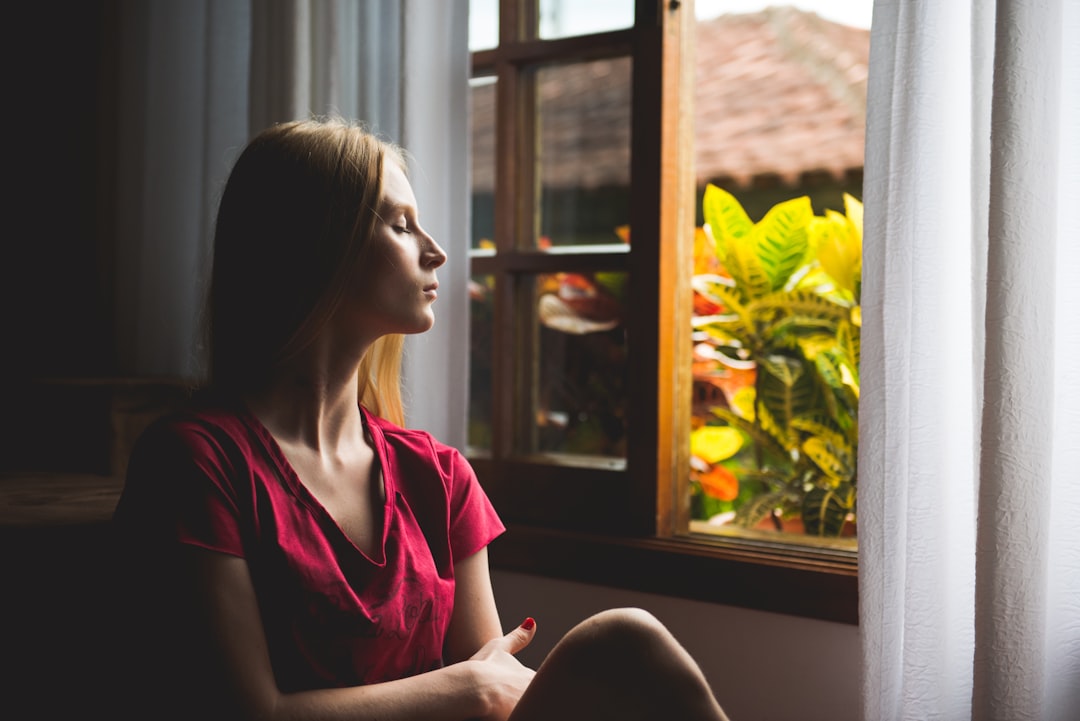 woman sitting near open window