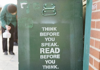 books over green trolley bin