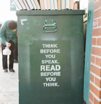 books over green trolley bin