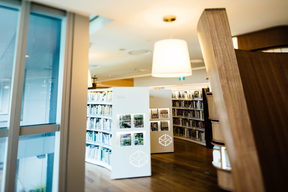 white wooden bookshelves inside room