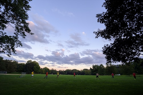 A group of mixed-ability players enjoying a soccer game on a sunny field.