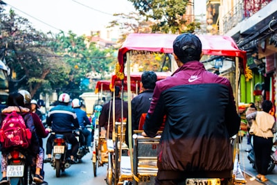 A busy street scene with couriers on bicycles and motorcycles.