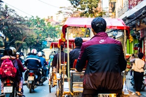 A vibrant street scene showing multiple SMV Wheels vehicles in action, highlighting sustainable transport in the community.