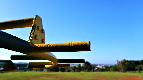 Close-up of hands fixing a galvanized tube on a playground structure