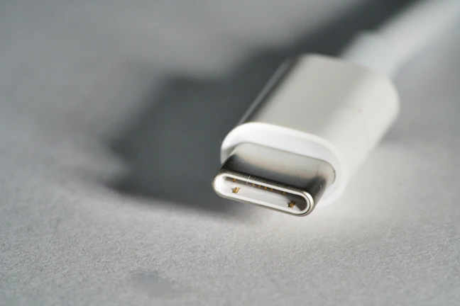 Close-up of a USB-C cable with a smooth matte finish against a dark blue gradient background.