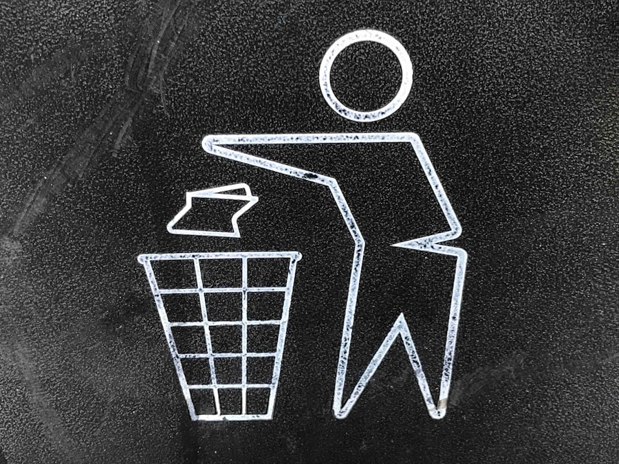 A recycling bin logo showing a stylized person throwing a piece of paper into a wastebasket.