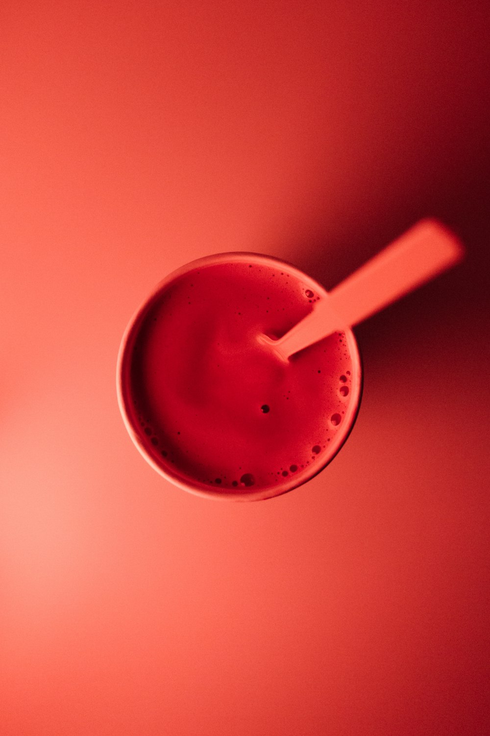 cup with brown liquid and spoon