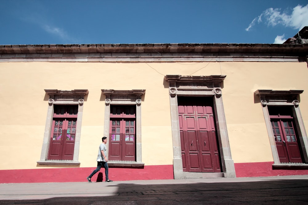 man wallking outside the building during daytime