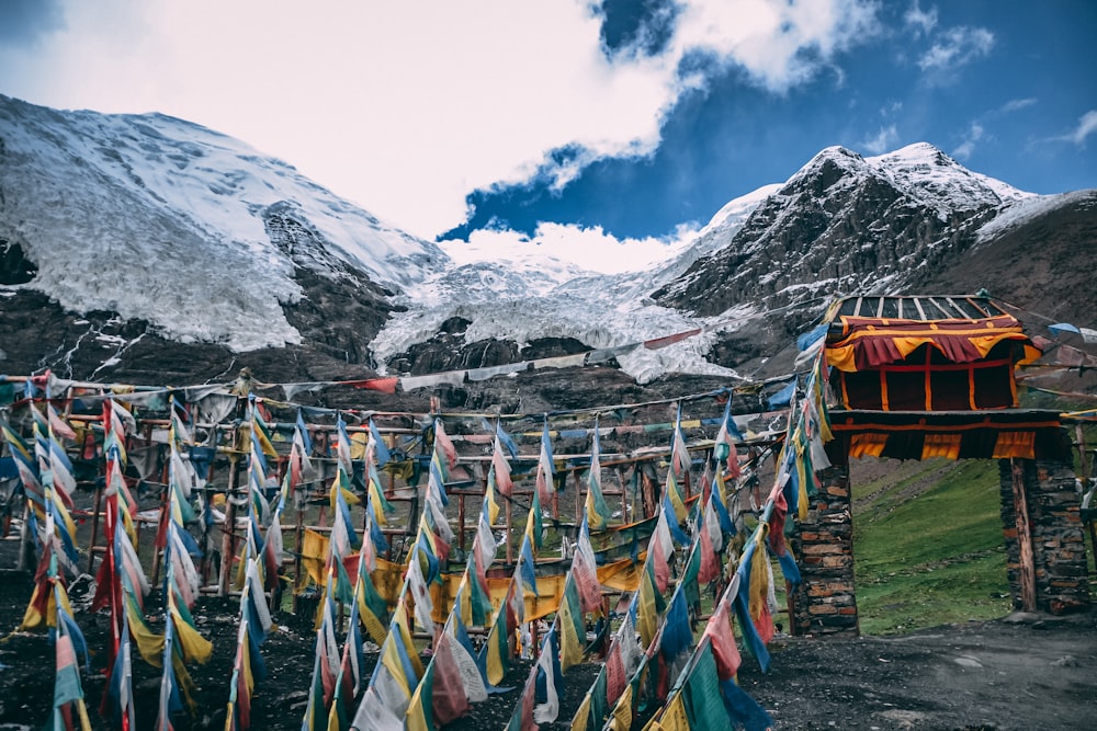 multicolored streamers near snow mountain under blue and white cloudy sky