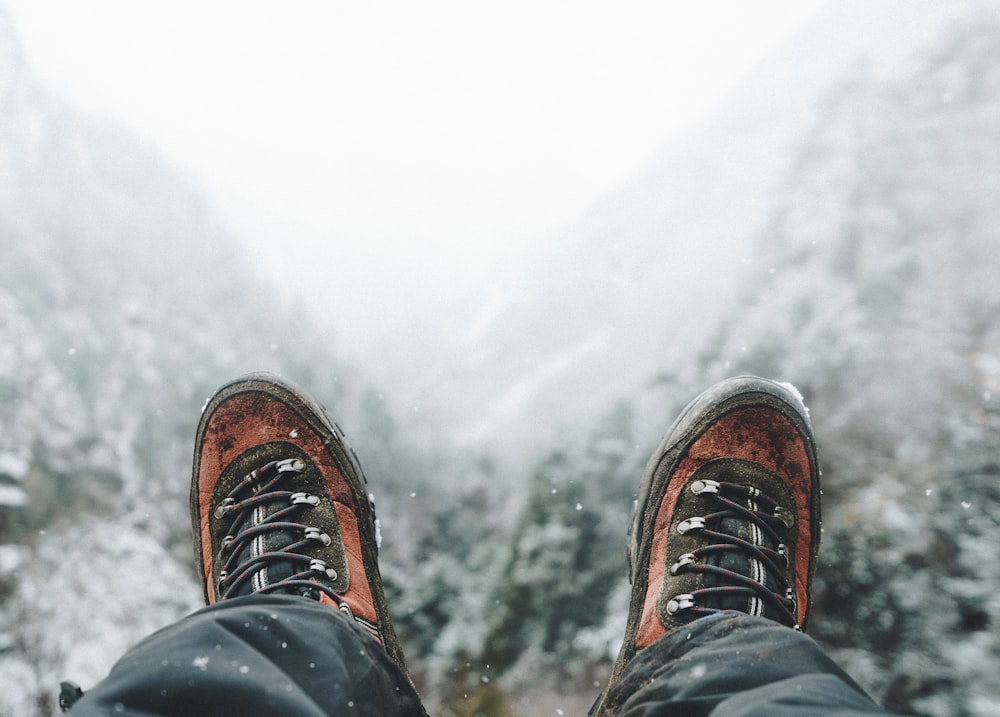 closeup photo of person wearing lace-up shoes