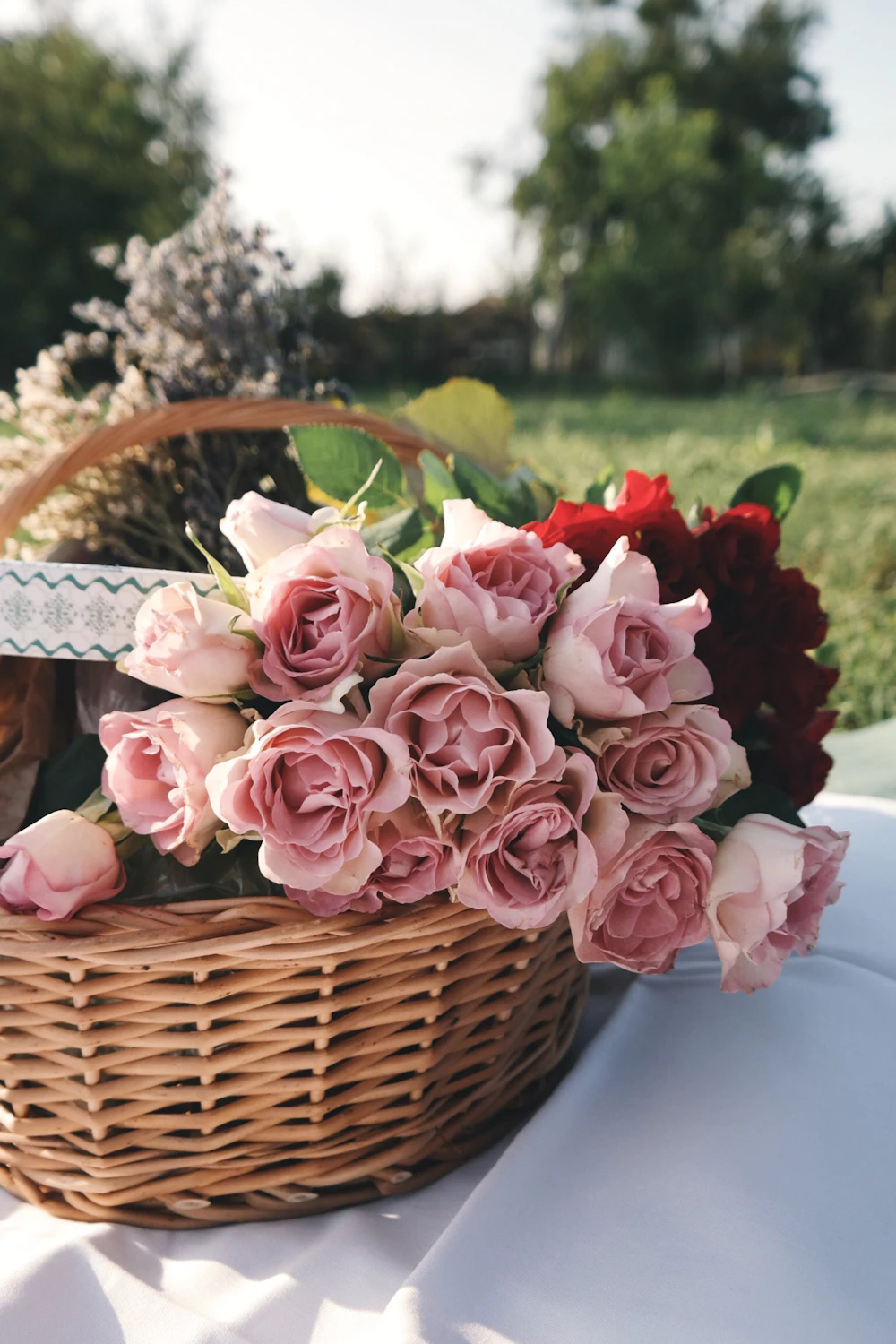 Pink rose resting on a woven wicker hamper basket
