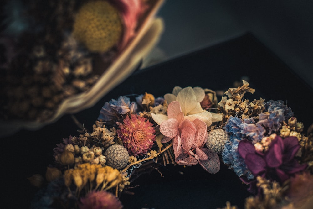 photo of flower wreath on black surface