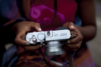 woman holding gray Fujifilm X100P