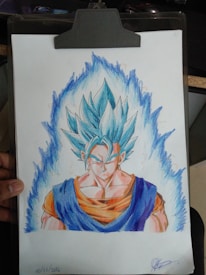 A detailed drawing showcases a muscular character with spiky blue hair, wearing an orange and blue outfit. The character is centered on a sheet of paper clipped to a board, surrounded by a blue energy aura. The drawing is hand-signed at the bottom with a date.