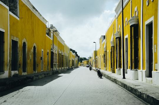 black motorcycle beside street during daytime in Izamal Mexico