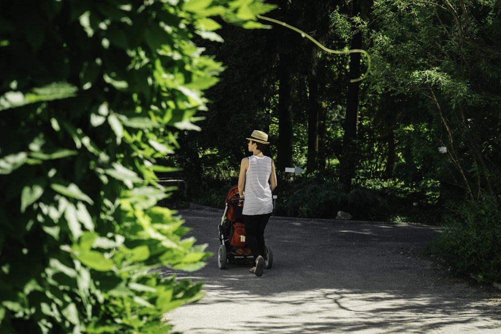 man in white and black long sleeve shirt riding red and black motor scooter during daytime