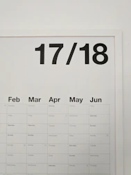 A sleek, branded calendar hanging on an office wall.