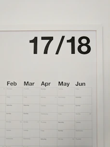 A sleek, branded calendar hanging on an office wall.