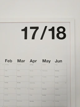 A sleek futuristic calendar highlighting football match dates with neon highlights.