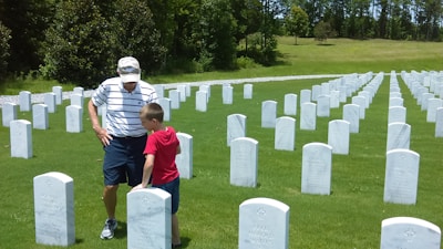 A fengshui expert giving advice to a family near a gravesite, showing traditional charts.