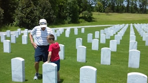 A respectful family visiting a gravesite, showing care and remembrance.