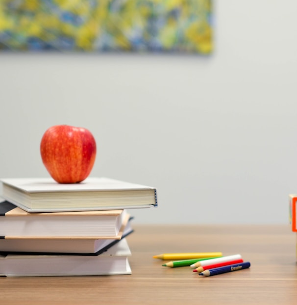 red apple fruit on four pyle books