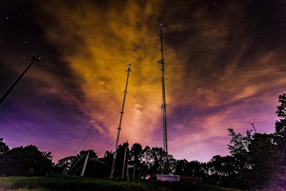 two brown utility poles during golden hour