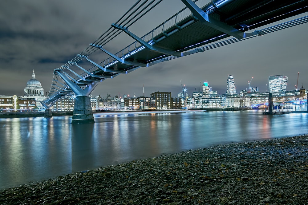 bridge near city scapes at nighttime