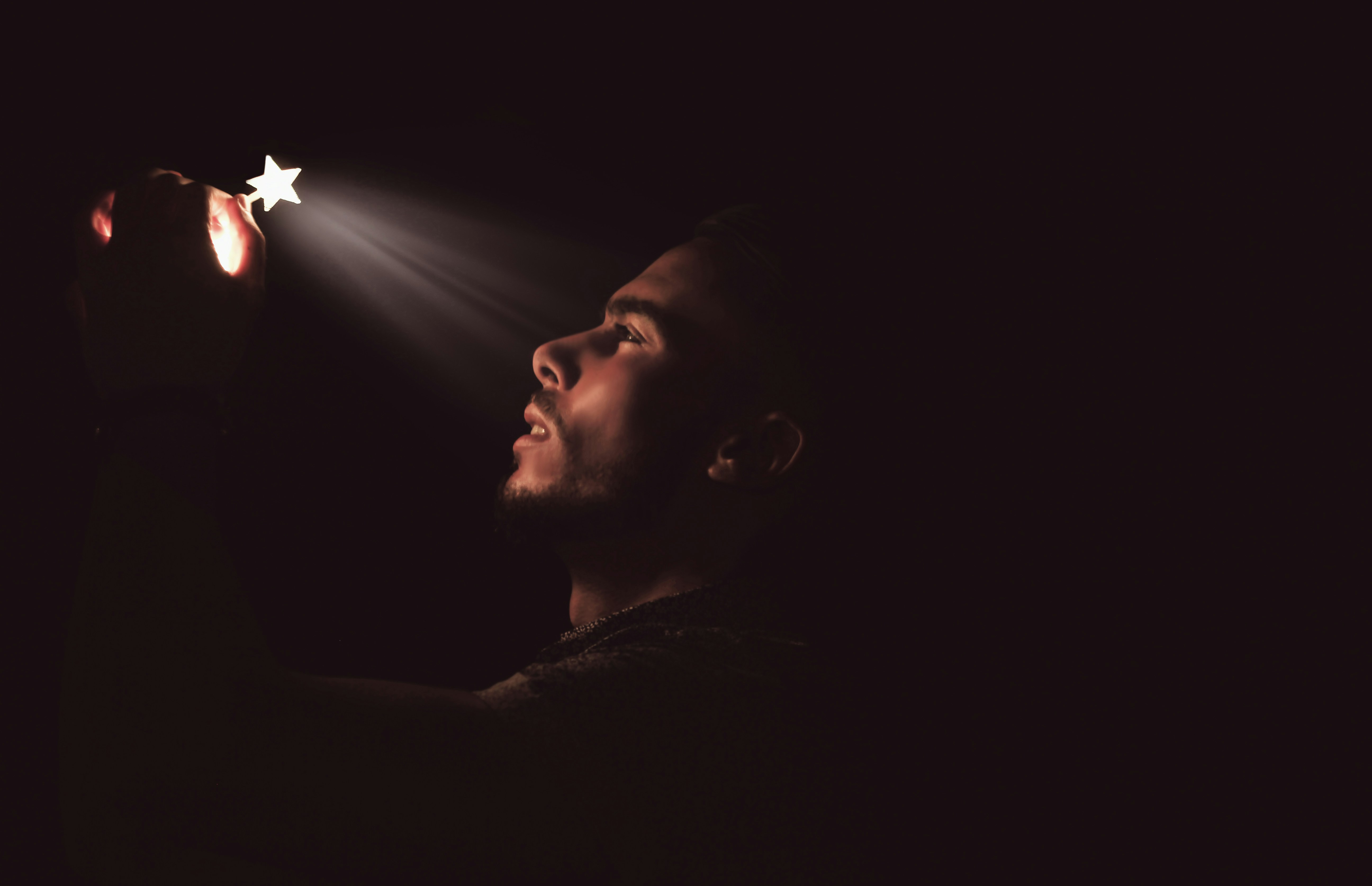 man holding white LED star