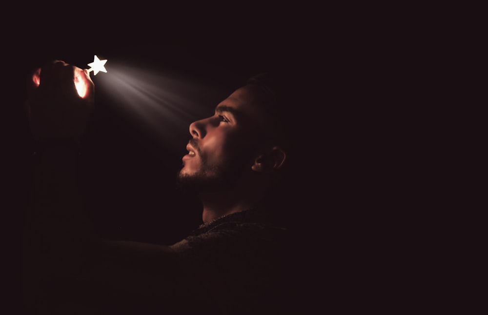 man holding white LED star