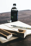 Artistic shot of tattoo tools and ink bottles arranged neatly on a rustic table