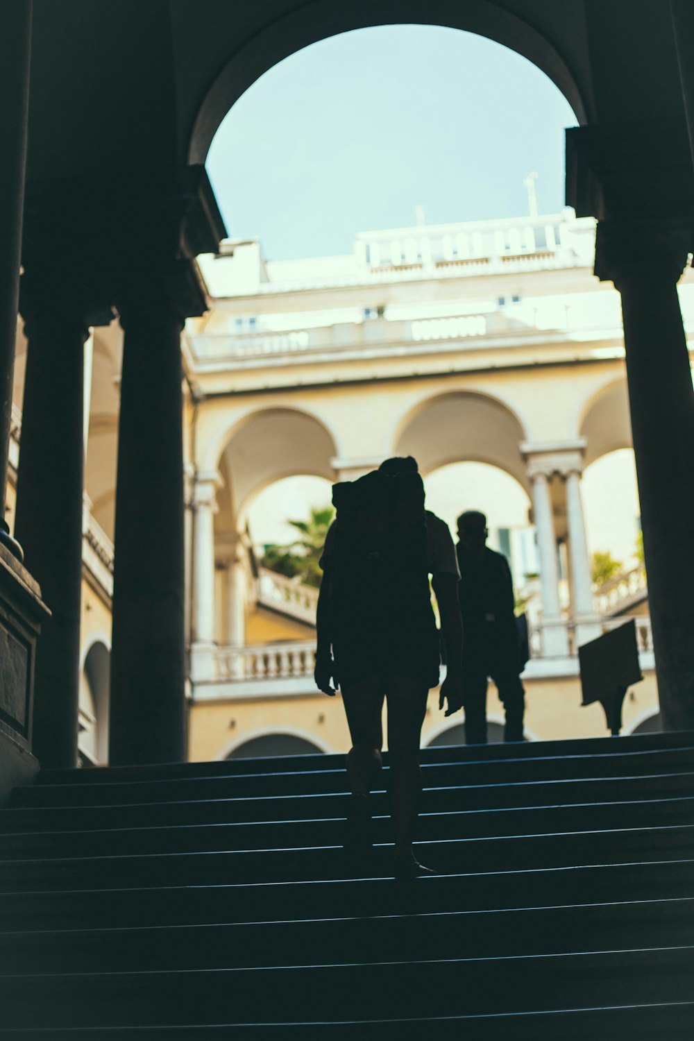 silhouette of person standing on stairs