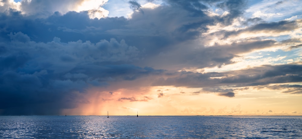 calm blue sea under blue and white skies