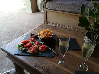 A table set with traditional Champenoise dishes and sparkling wine, inviting a taste of local gastronomy.