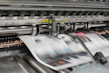 Close-up of a high-quality offset printing machine in action with crisp paper sheets.