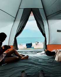 Interior of spacious Ocean Tent featuring comfortable bedding and sea-view windows open to gentle ocean breeze.