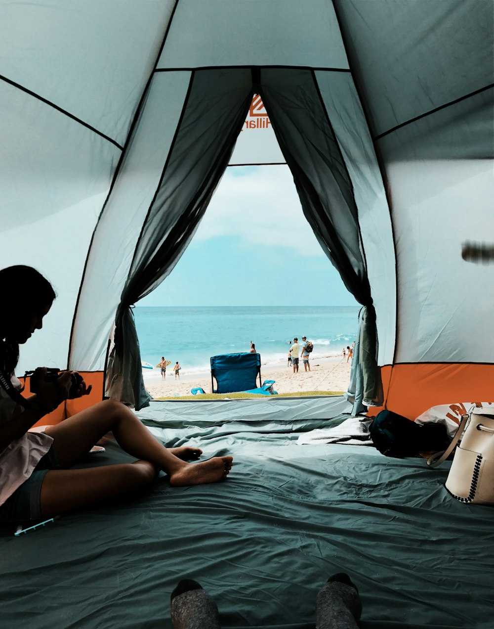 photo of person sitting inside the tent