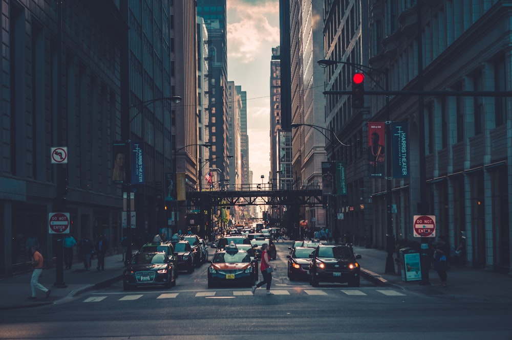 woman crossing pedestrian lane towards building during daytime