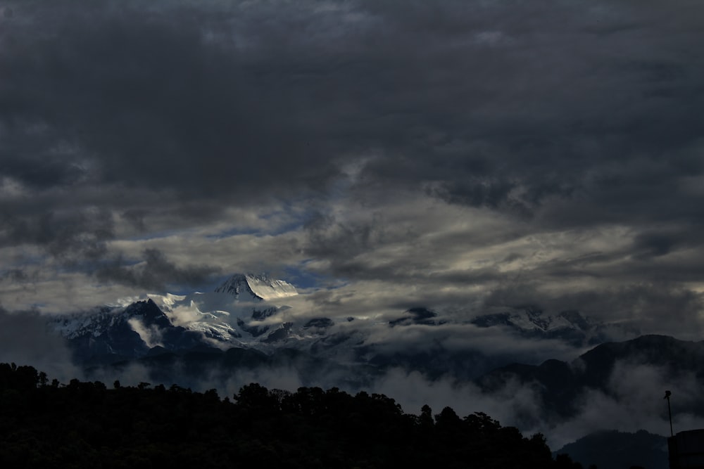 photo of rock mountain covered with snow