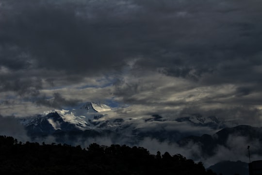 photo of rock mountain covered with snow in Pokhara Nepal