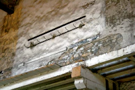 Close-up of charred wooden beams contrasted with fresh, repaired drywall in a Brooklyn apartment.
