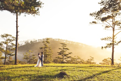 A happy couple exploring a lush green hill station on their honeymoon.