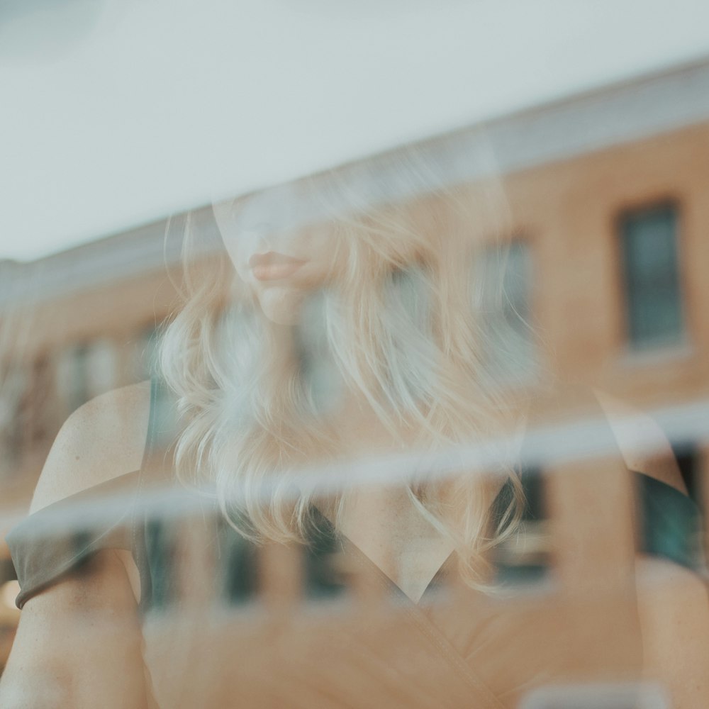 reflection of woman on glass