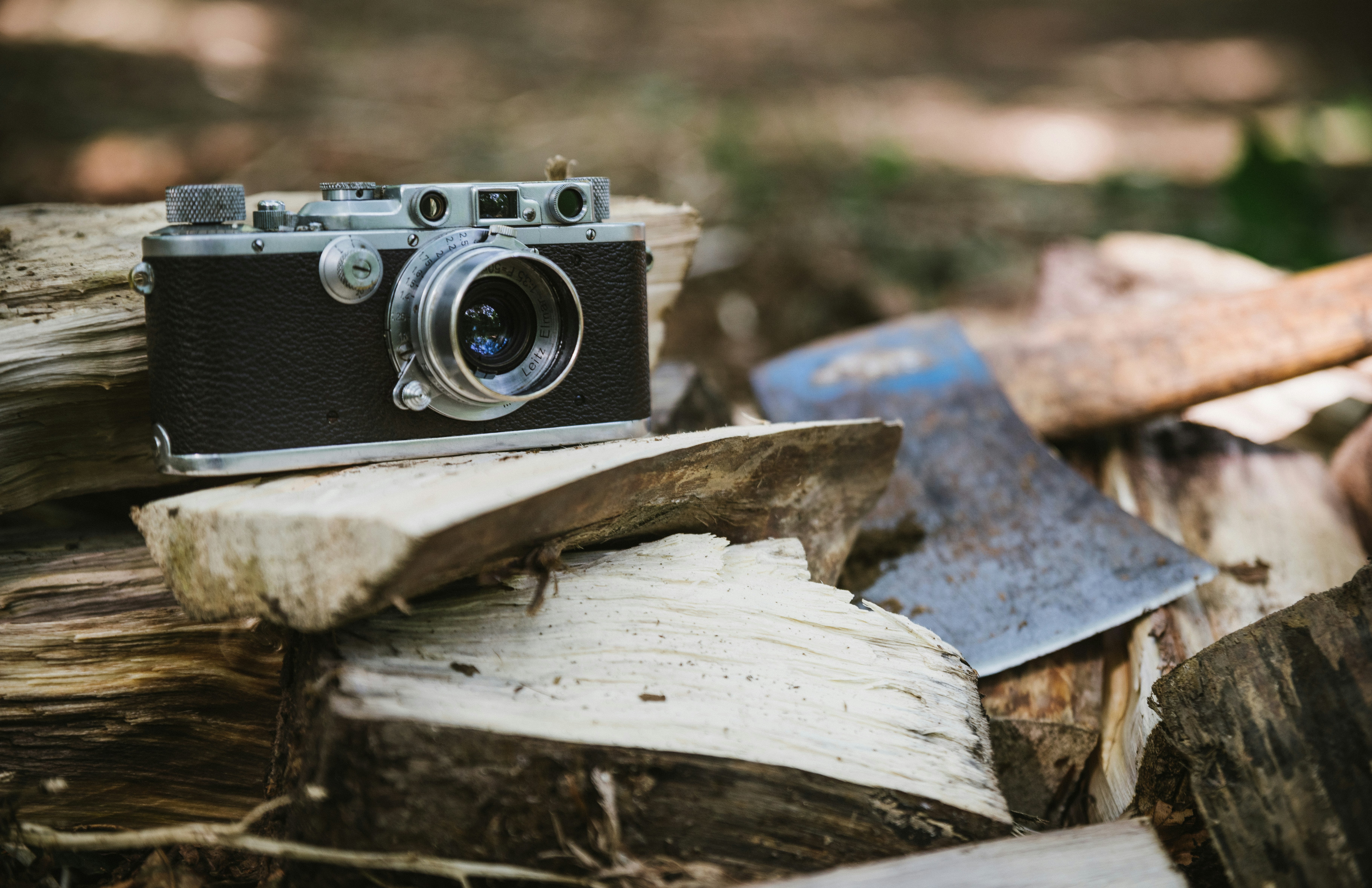 black and gray camera beside axe