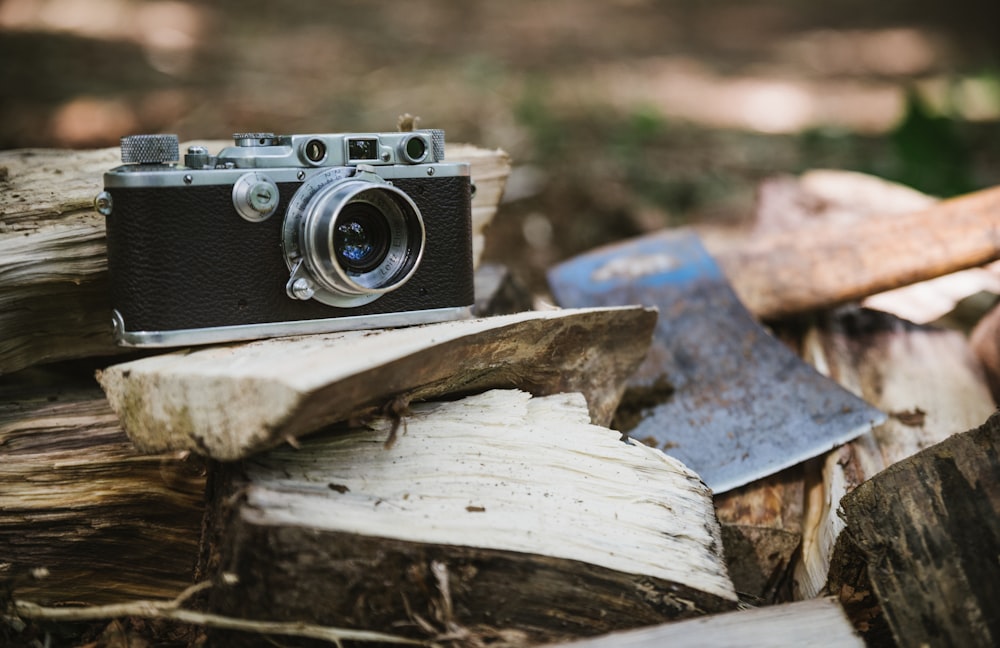 black and gray camera beside axe