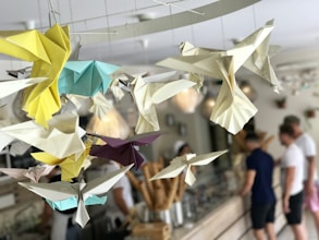 white, yellow, and teal paper bird decorations