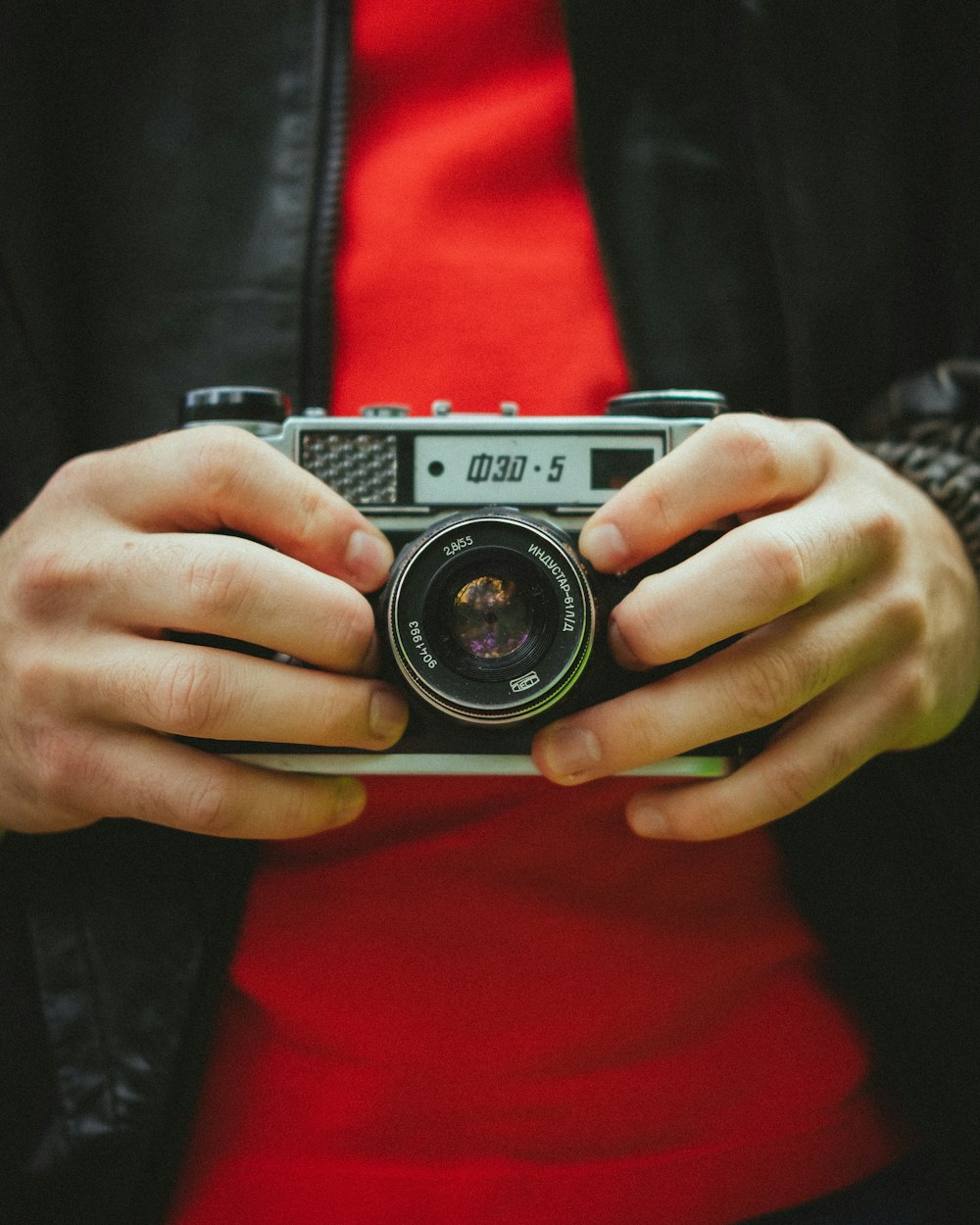 person holding gray and black camera