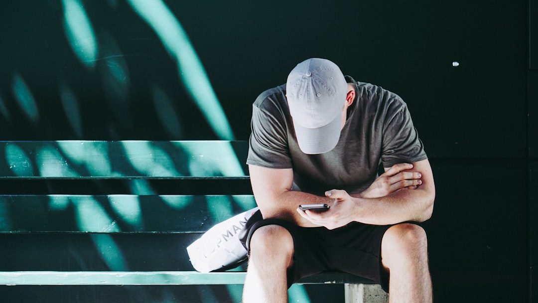 man using smartphone white sitting