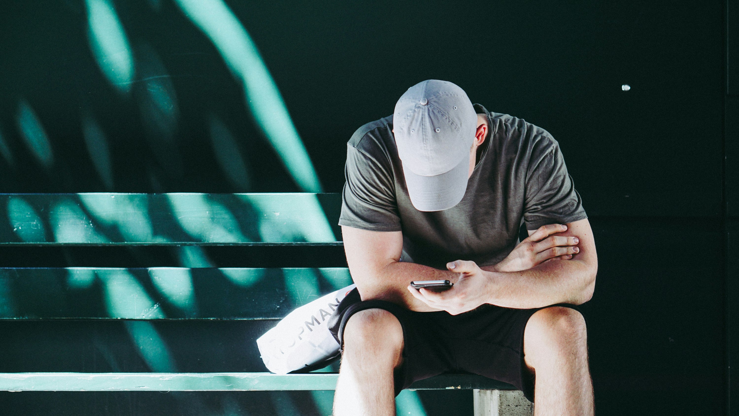 man using smartphone white sitting