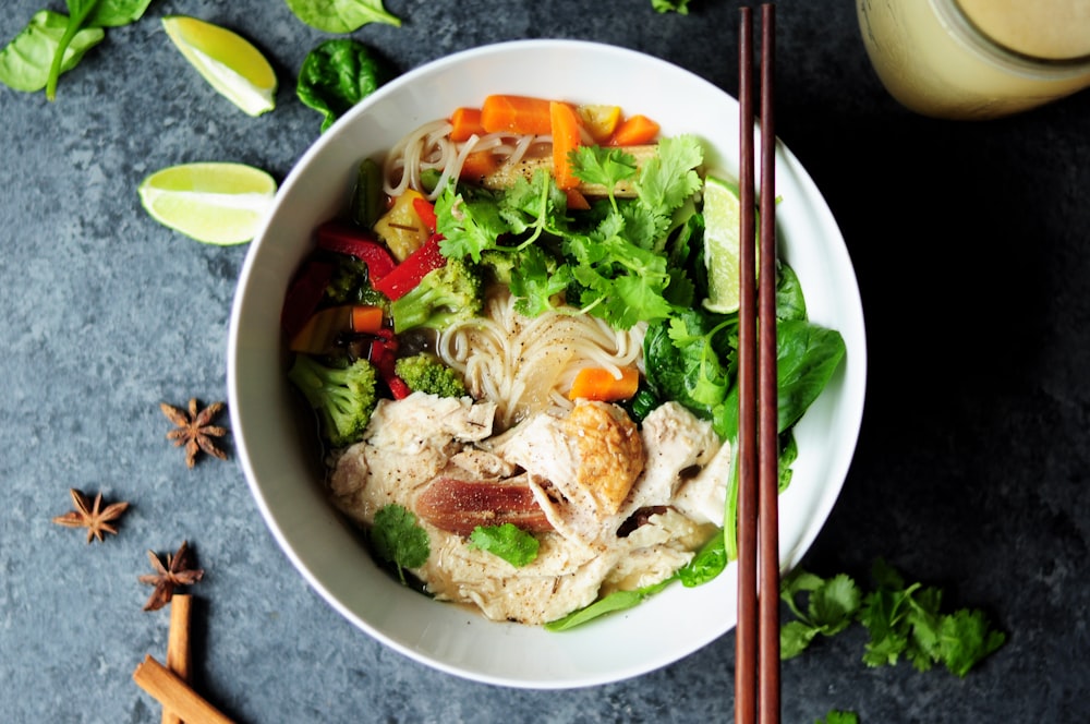 brown chopsticks on white bowl